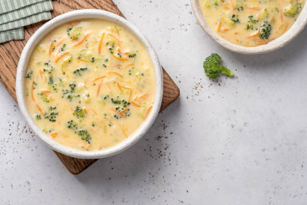 Bowl of broccoli and cheddar soup Bowl of broccoli and cheddar cheese soup soup stock pictures, royalty-free photos & images