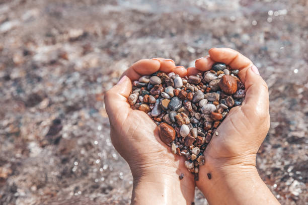 istock Hands holding small stones form heart shape 1390840487