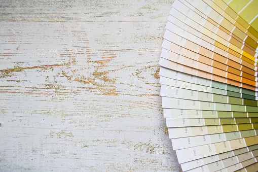 Paper Fan paint samples interior design wall painting natural Colors. Wooden background, copy space.