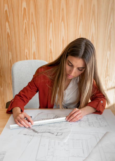 istock Young and beautiful woman working in architectural project 1390844269