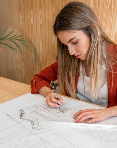 istock Front view portrait of woman architect drawing sketches 1390844270