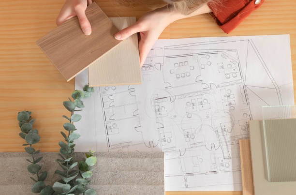 Top view of interior designer material sample moodboard on wood desk