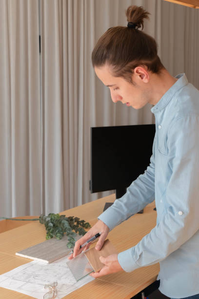 Interior design professional showing material samples to client at the office