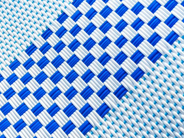 Abstract white and blue rattan pattern background. Close-up checkered pattern caused by the interweaving of white and blue lines, top view.