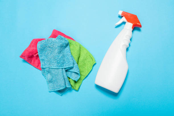 istock Detergent for various surfaces and a rag on a blue background. Professional cleaning products, general cleaning. Household chemicals 1390848045