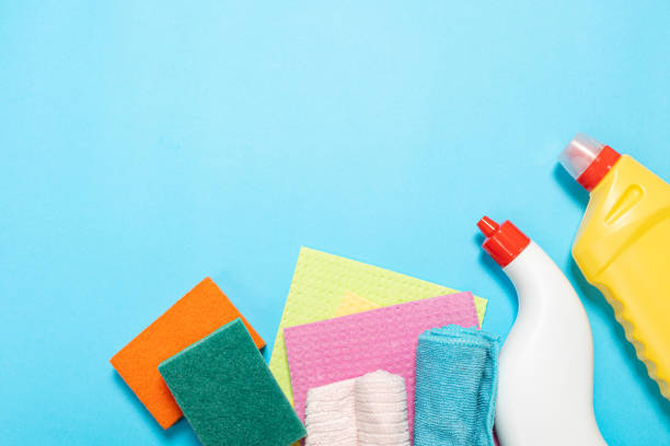 istock bottles and sprays cleaning agent brushes sponges rags on a colored background on the side. Professional cleaning products, general cleaning. Household chemicals 1390848109