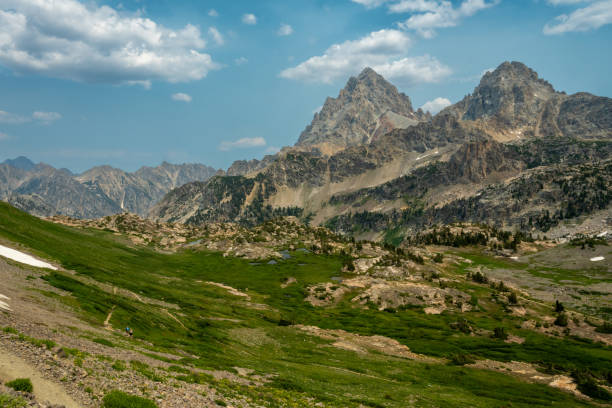 istock Hikers Dwarfed By The Surrounding Tetons 1390848720