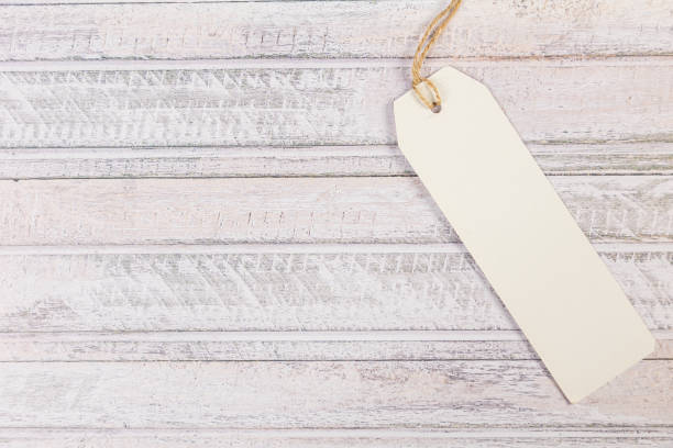 istock white Blank tag on a light wooden background 1390848927