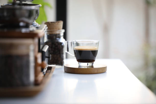 istock Espresso glass cup on wooden tray on white table 1390849860