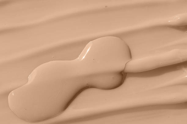 istock Cosmetic tonal moisturizer, bb cream swatch sample. Beige nude liquid foundation texture, concealer smear smudge drop. Make up base, cream textured background. 1390850080