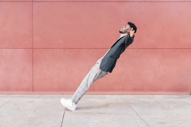 african-american man falling backwards onto concrete floor - bending over backwards imagens e fotografias de stock