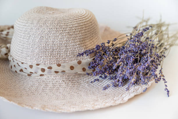 Summer hat with polka dot ribbon and lavender bunch. High quality photo.