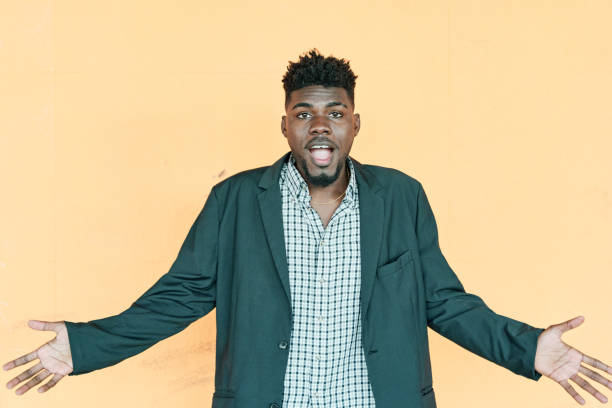 istock Doubtful African American man shrugging shoulders, feeling confused. Young hipster man with casual jacket looking at camera 1390851148