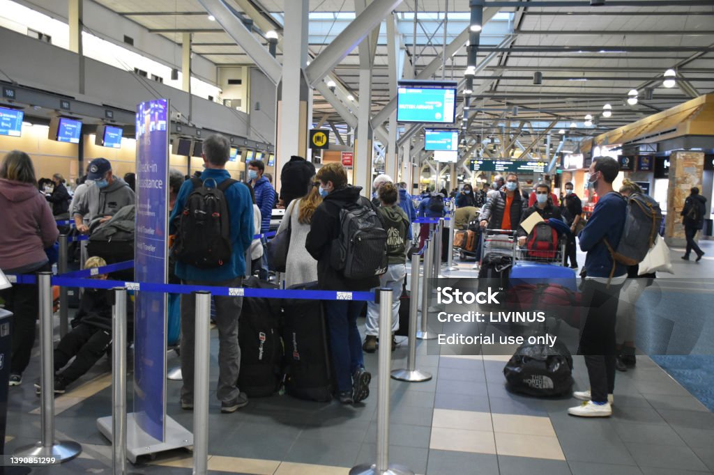 Vancouver International Airport, British Columbia, Canada, People, Luggage View People Walking, Standing, Wearing Non Medical Face Mask Due To COVID-19 Pandemic, Checking In Their Luggage At Vancouver International Airport In British Columbia Canada Airport Stock Photo