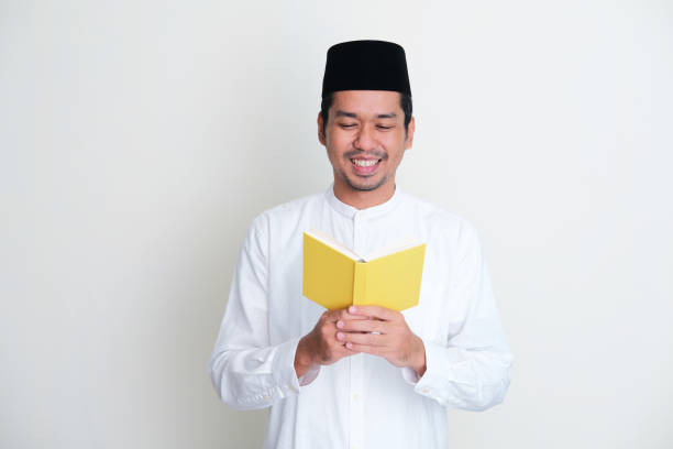 istock Moslem Asian man smiling when reading a book 1390852207