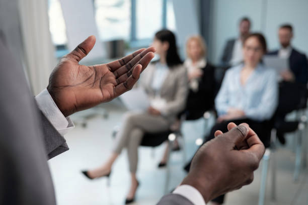 istock Hands of young African American coach explaining data to audience 1390852857