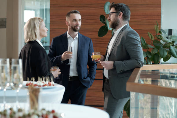 istock Three confident entrepreneurs in formalwear having juice and champagne 1390852955