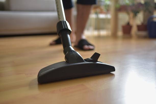 istock man vacuums the floating floor 1390853909