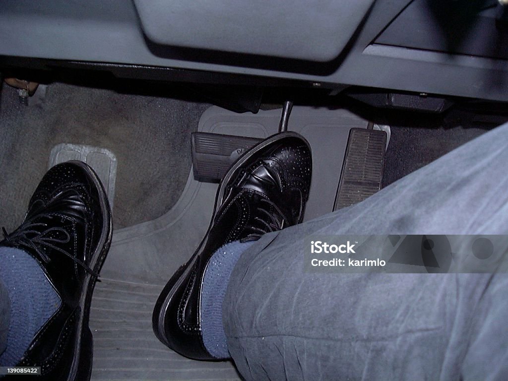 feet driving driving a car. Close up on my feet while driving to work. Animal Body Part Stock Photo