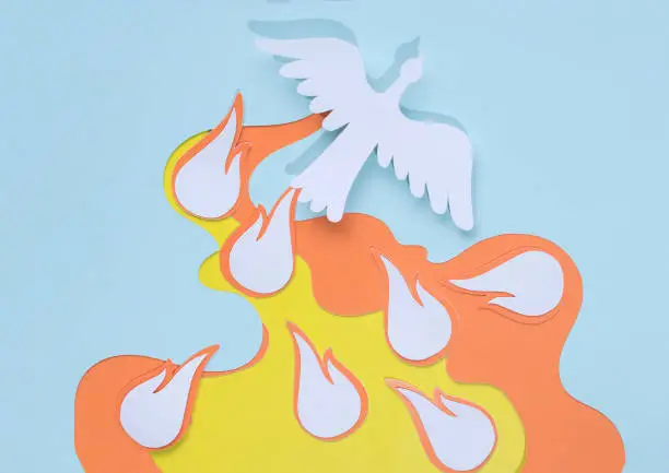 paper silhouette of a white dove depicting the holy spirit and flames with seven gifts