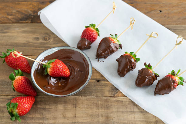 istock Strawberries with chocolate. Strawberries dipping process in chocolate. Copy space. 1390855517