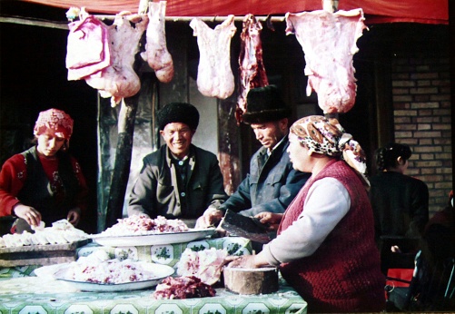 Shop owners and clerks are sorting mutton in preparation for sale.Film was taken in Hotan, Xinjiang province in 1996