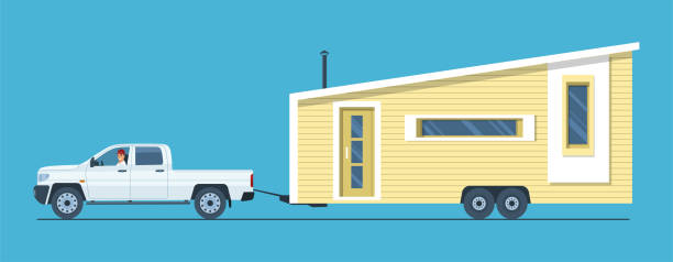 istock A pickup truck with a man at the wheel is towing a tiny house. Vector illustration. 1390858036