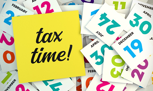 Tax Time Post-it and Close Up Colorful Calendar Date Pages. Reminder Note Concept.