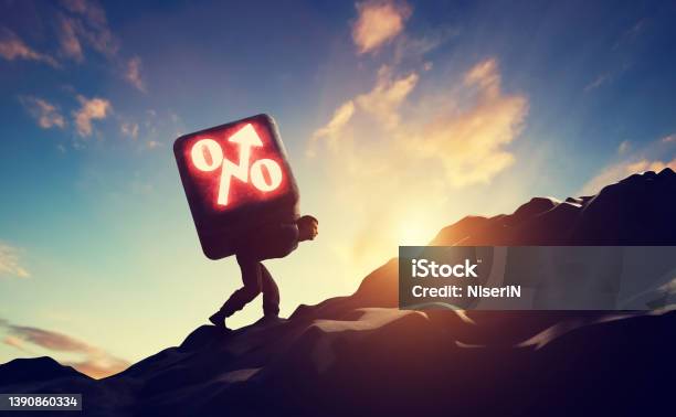 Man Carrying Heavy Stone With Growing Interest Rate Symbol Stock Photo - Download Image Now