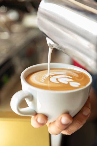 istock barista pouring cup of coffee 1390861268