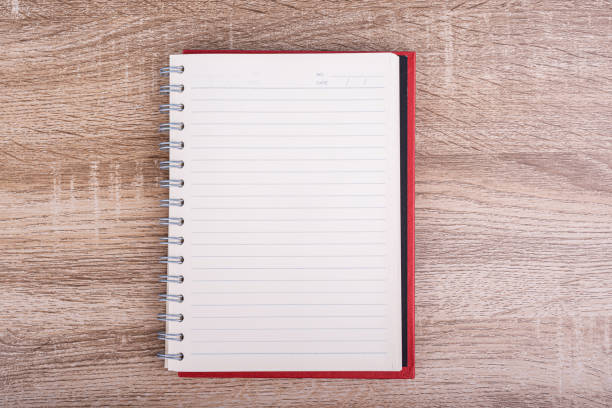 Top view of Open diary  or note book put on wooden table.