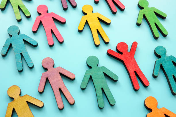 istock Diversity and equity concept. Multi-colored figurines of people. 1390861409