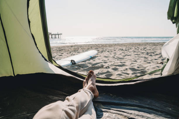 istock A man is relaxing inside his tent on the beach 1390861643