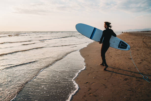 istock A man is running to the sea with his surfboard 1390861739
