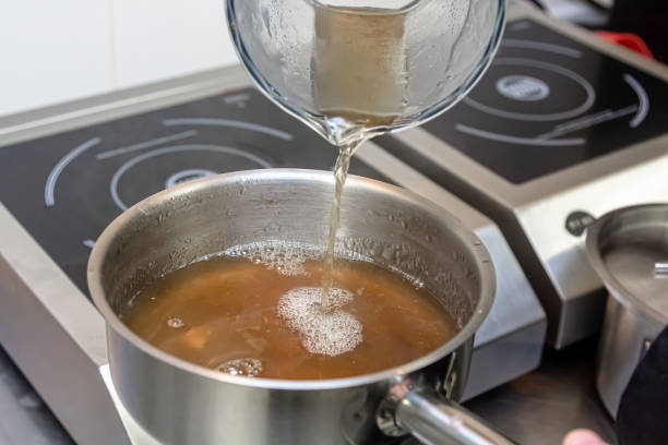 istock The cook pours boiling broth into a saucepan 1390862687