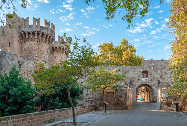 The Gate of Saint Antony and the tower of Saint Mary in the entrance of the medieval ton of Rhodes, Greece. St. Anthony’s Gate, the historic and most popular entrance to the medieval town, with the round tower of Saint Mary, designed to guard the gate. old town stock pictures, royalty-free photos & images