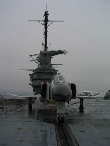 Aircraft Carrier with Aircraft on a misty day.