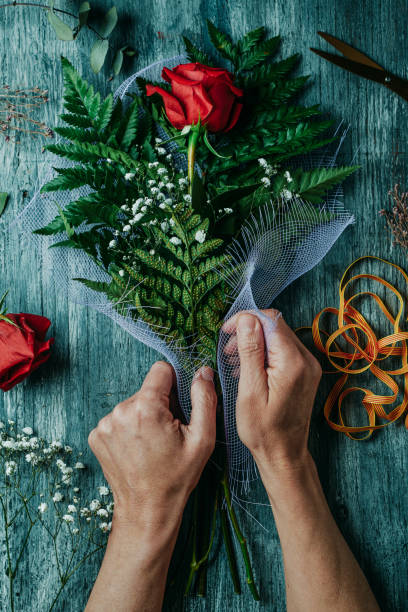 istock arranging a bouquet with a red rose for Sant Jordi 1390865926