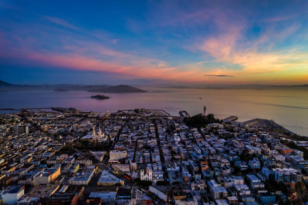 Aerial Sunrise over San Francisco Bay Aerial view of sunrise over San Francisco Bay with Alcatraz in the distance and a kaleidoscope of colors above North Beach. san francisco bay stock pictures, royalty-free photos & images