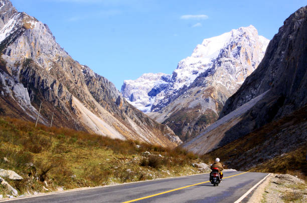 istock Ganzi County within the snow mountains under the road, a motorcycle drove through 1390867191