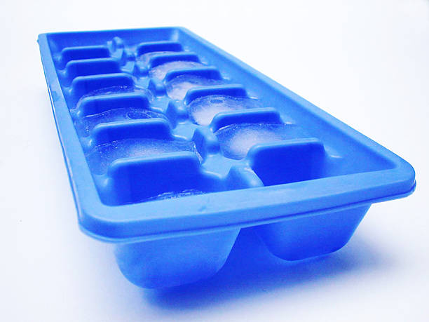 Blue ice cube tray with frozen water isolated on white
