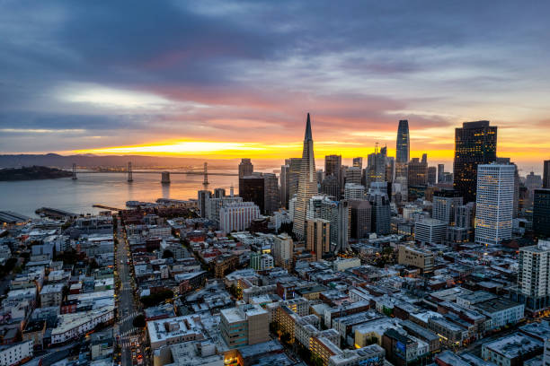 Aerial Sunrise over San Francisco Aerial view of sunrise over San Francisco Financial District with iconic buildings and the bay. san francisco bay stock pictures, royalty-free photos & images