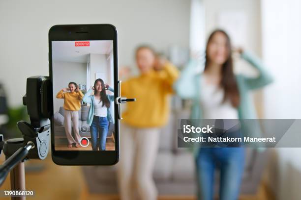 Asian Young Woman With Her Friend Tiktoker Created Her Dancing Video By Smartphone Camera Together To Share Video To Social Media Application Stock Photo - Download Image Now