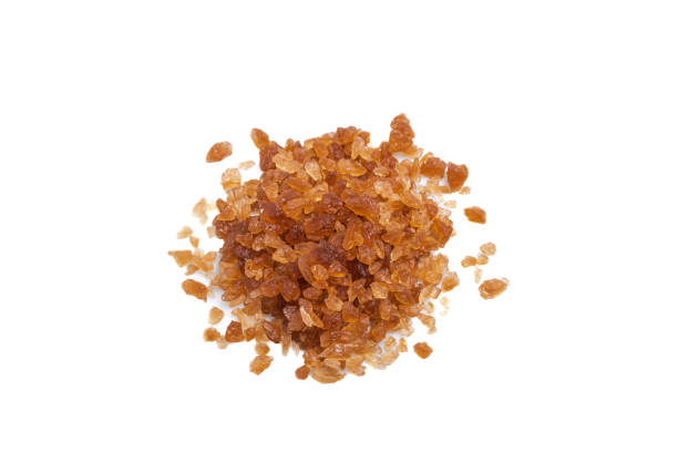 istock Top view large grains of rock sugar piled together on a white background. 1390868342