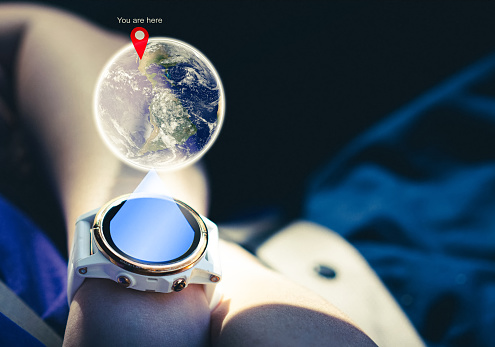 gps watch for routing map to destination on wrist with globe hologram The source of the map from https://www.nasa.gov/