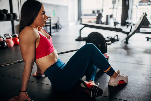 istock Fit woman sitting in gym 1390872386