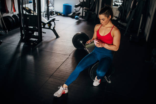 istock Fit woman sitting in gym 1390872578