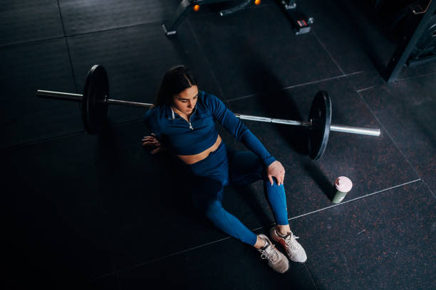 istock Fit woman sitting in gym 1390872643