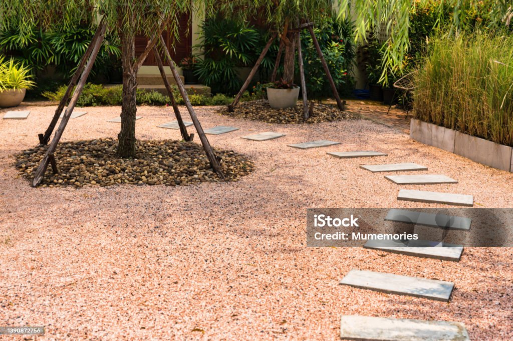 Zen stone path on gravel floor in the garden Zen stone path on gravel floor in japanese garden Abstract Stock Photo