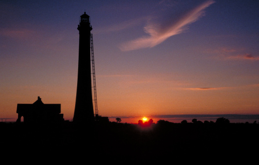 A sunset silhouette of the Fire Island Lighthouse, Fire Island National Seashore, Long Island, NY.